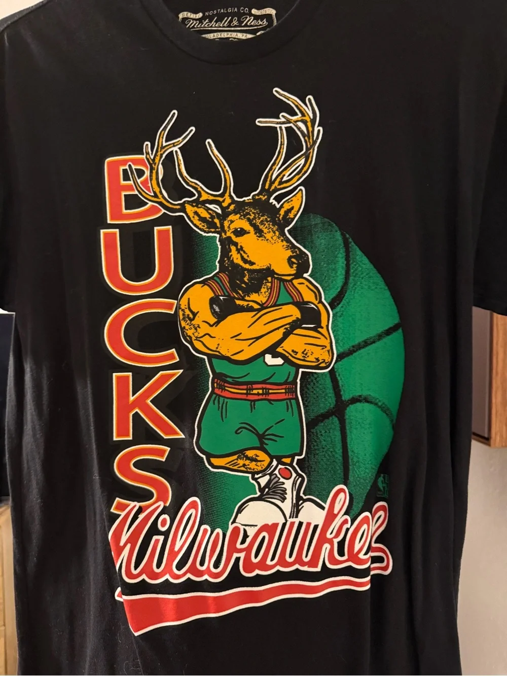 Mitchell & Ness Black Milwaukee Bucks Graphic Tee with Green and Gold Artwork